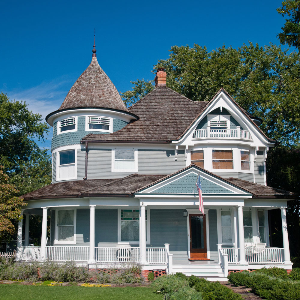 A spacious house with a grand porch, offering ample space for relaxation and outdoor activities.